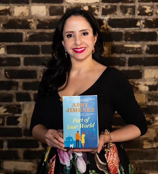 Picture of author Abby Jimenez holding her book "Part of Your World"