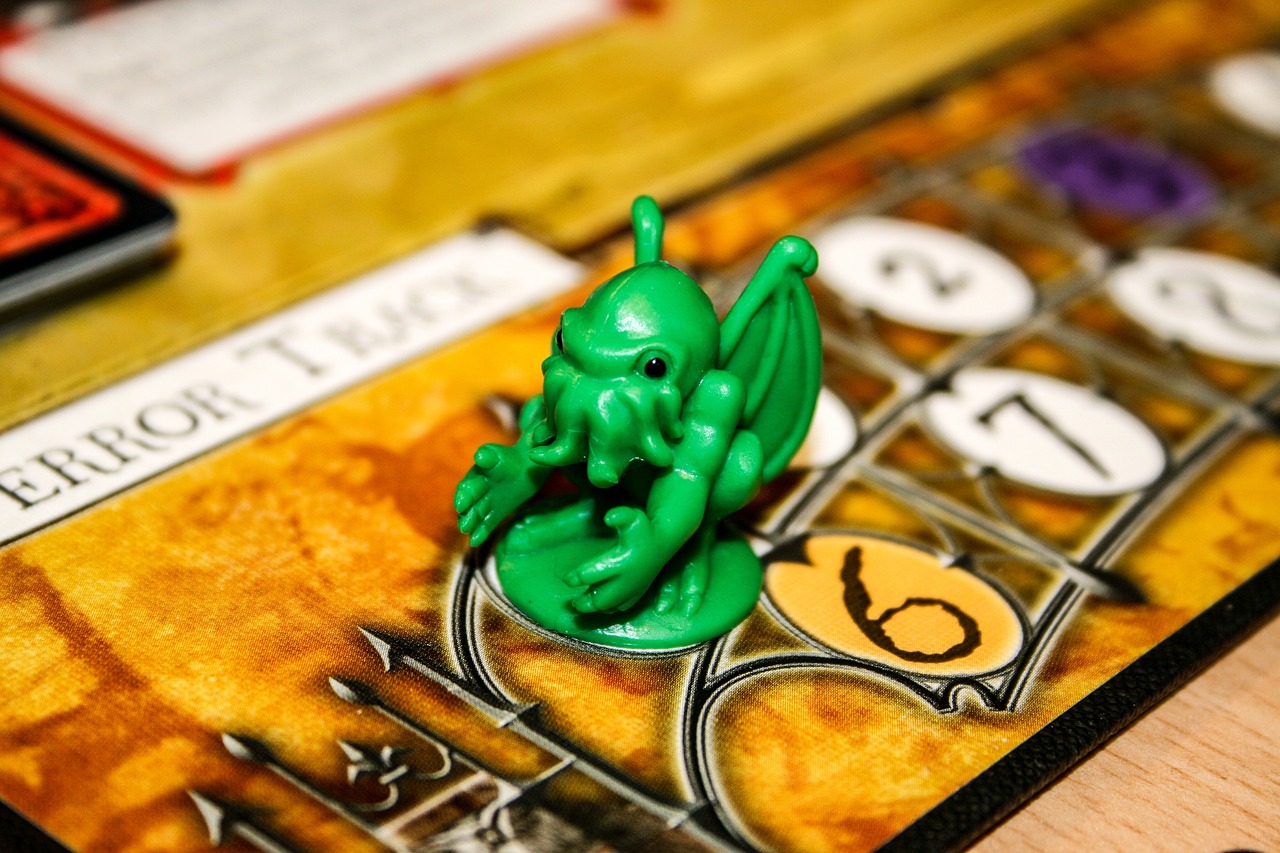 Picture of a Cthulhu figure sitting on a board game