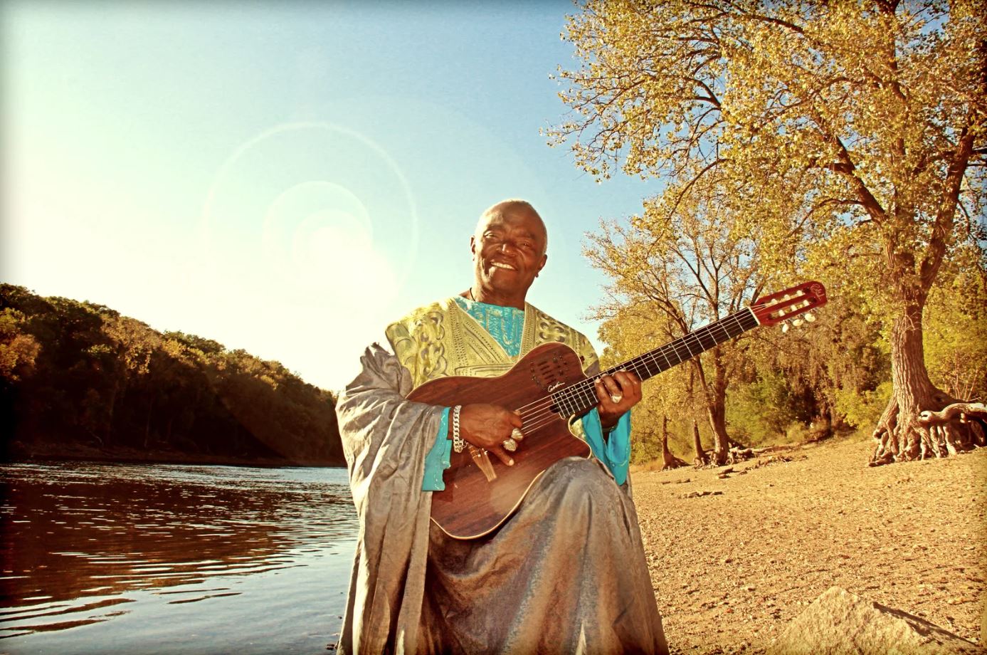 Siama playing Guitar by Mississippi River 