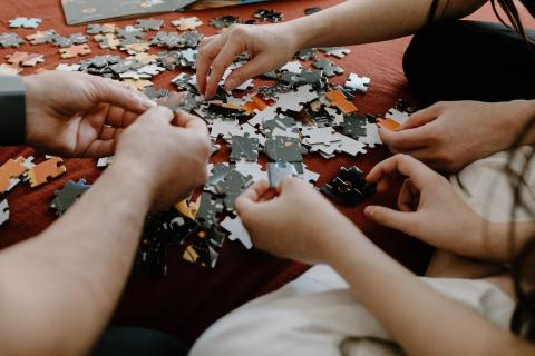 hands doing a jigsaw puzzle