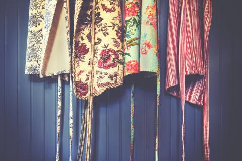 aprons hanging against a wall