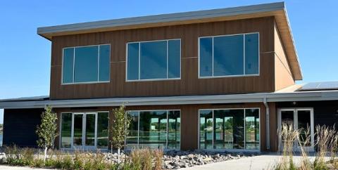 photo of building with windows overlooking lake