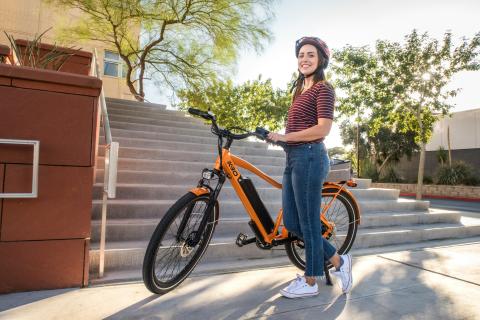 woman standing in front of a bike