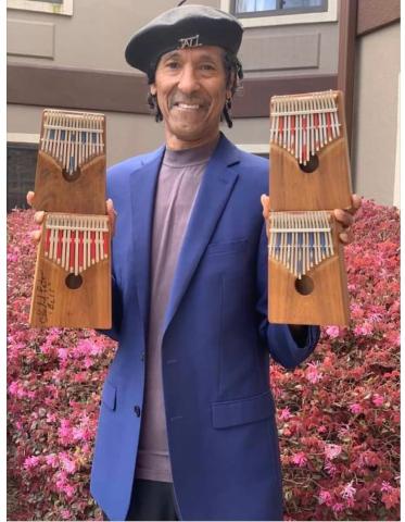 Carl Winters holding 4 kalimbas