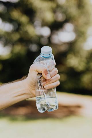 hand crushing plastic bottle