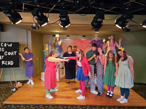 actors on stage in colorful costume