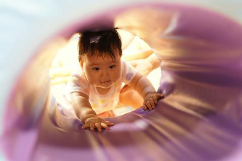 baby crawling in tunnel