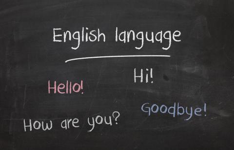 Chalkboard with words "English language" "Hello" "Hi" "How are you?" "Goodbye!"