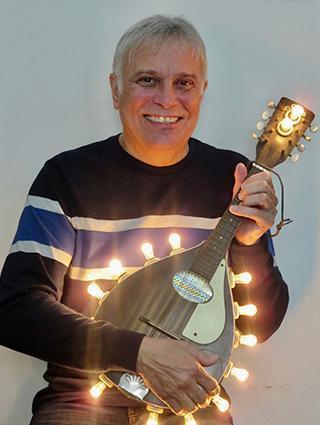 smiling man holding stringed instrument