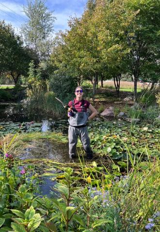 Gardener standing in a pond