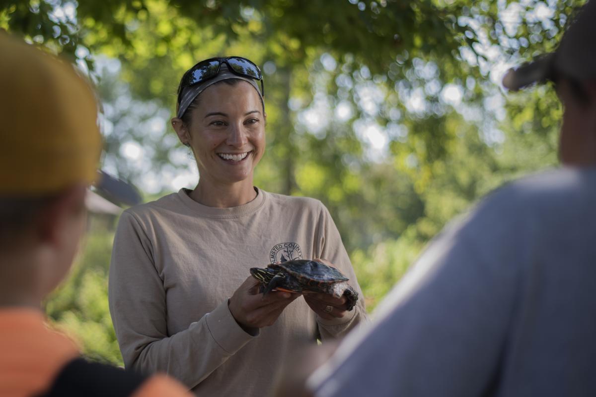 Naturalist from Zollman Zoo holding turtle