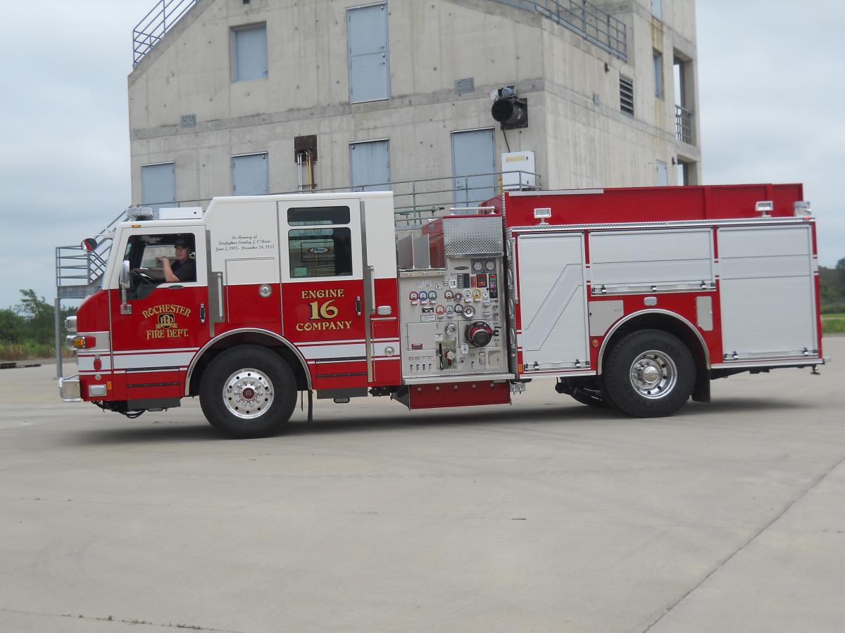 red fire truck in lot in front of building