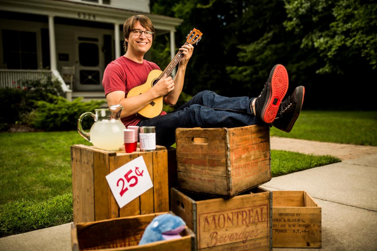 Justin Roberts playing ukelele at lemonade stand