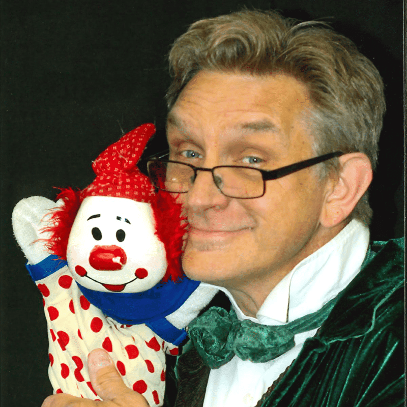 man with clown puppet