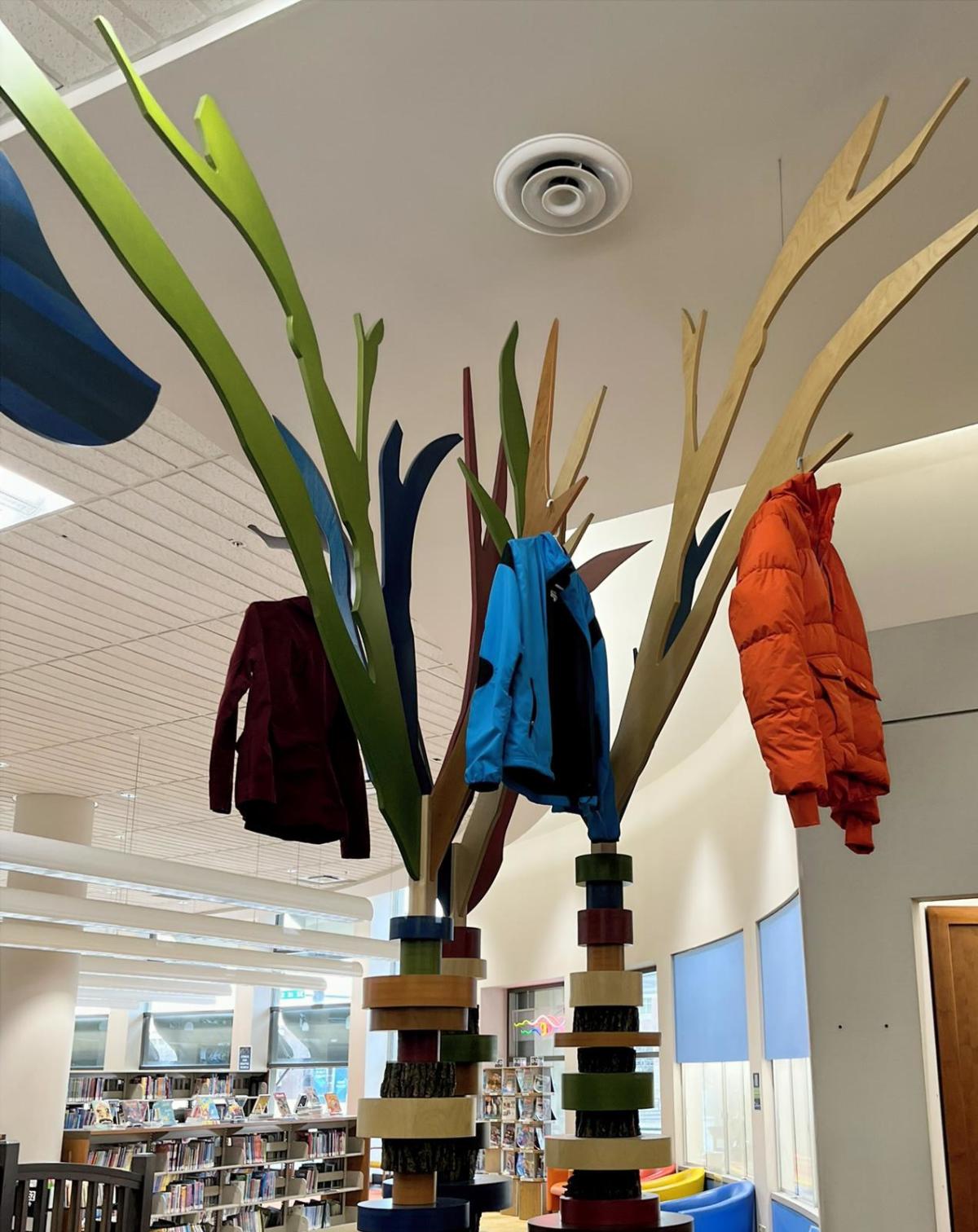 coats on hangers in tree scupture