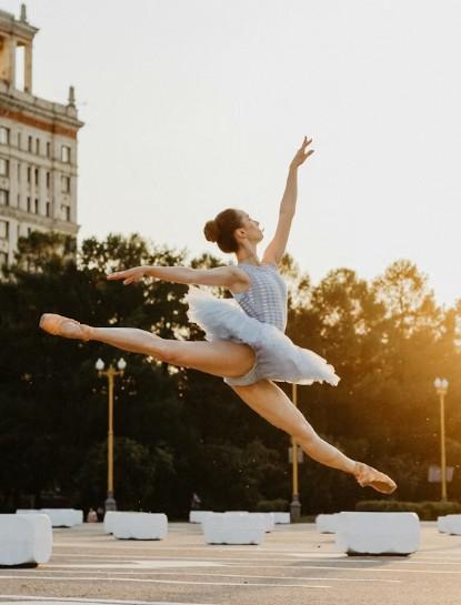 ballerina leaping in sunset